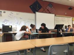 3 students at table debating 3 students at table debating